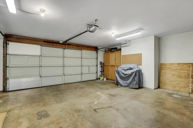 a view of a patio with table and chairs under an umbrella