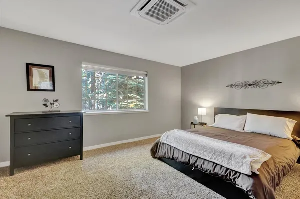 a front view of a house with a garden and parking