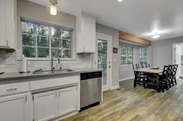 a bedroom with a bed and a flat tv screen on dresser