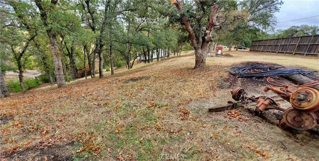 a view of backyard with wooden fence