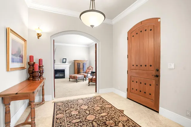 a living room with fireplace furniture and a large window