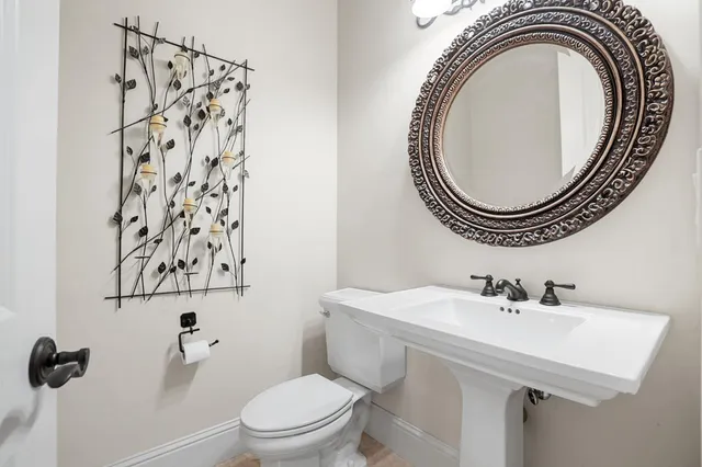 a large kitchen with stainless steel appliances granite countertop a stove and a view of living room