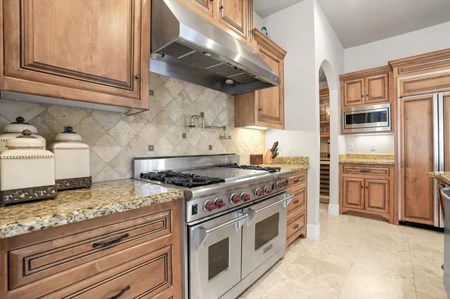 a spacious bathroom with a granite countertop sink a mirror and shower