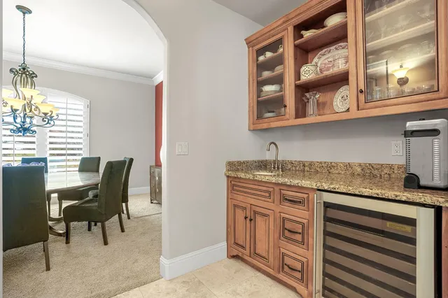 a spacious bedroom with a bed and a chandelier