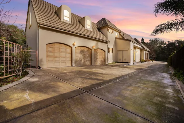 a view of a white house with a yard