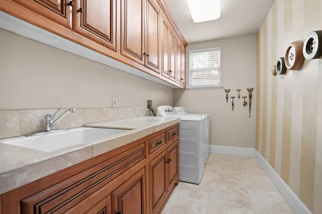 a view of a patio with table and chairs and potted plants