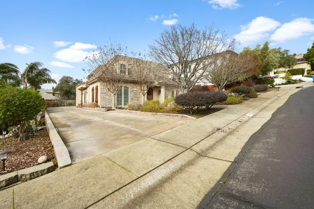 a front view of a house with garden