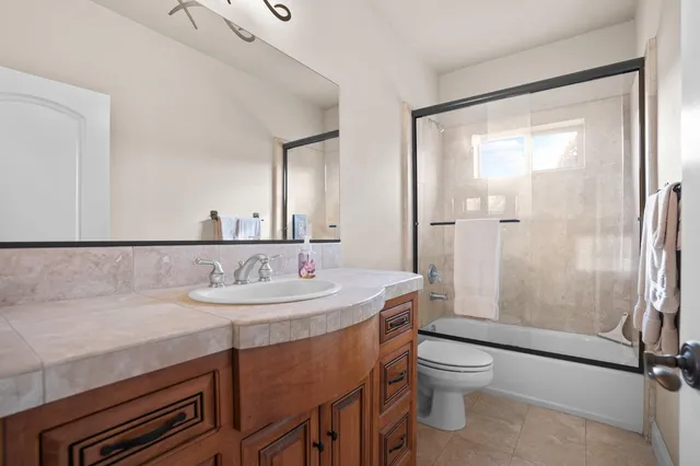 a view of backyard and wooden fence