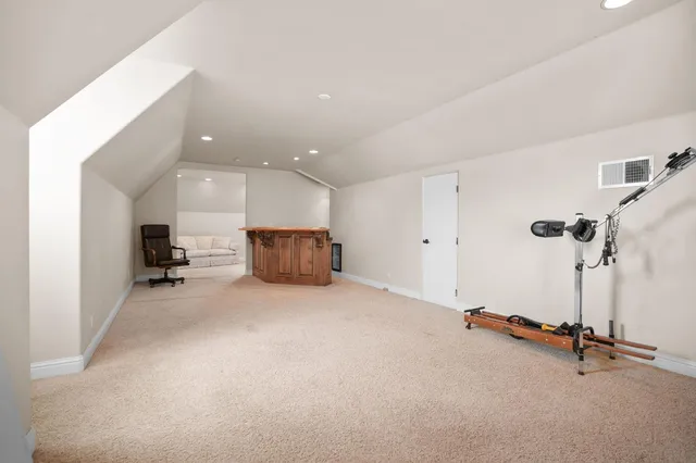 an aerial view of a house with a mountain