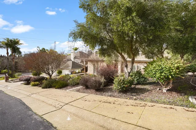 a dining room with furniture a chandelier and wooden floor