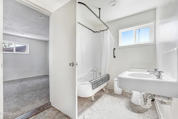 a spacious bathroom with a sink and a mirror