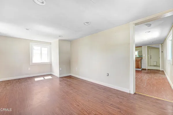wooden floor in an empty room with a window