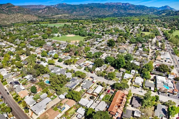an aerial view of residential houses with outdoor space