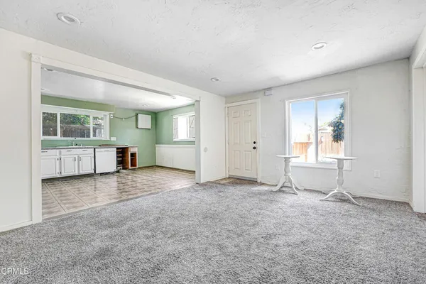 an empty room with windows and entrance