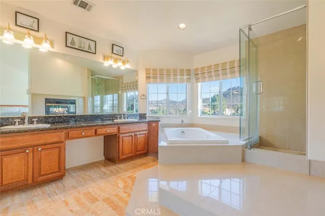 a large spacious bathroom with a large tub and shower