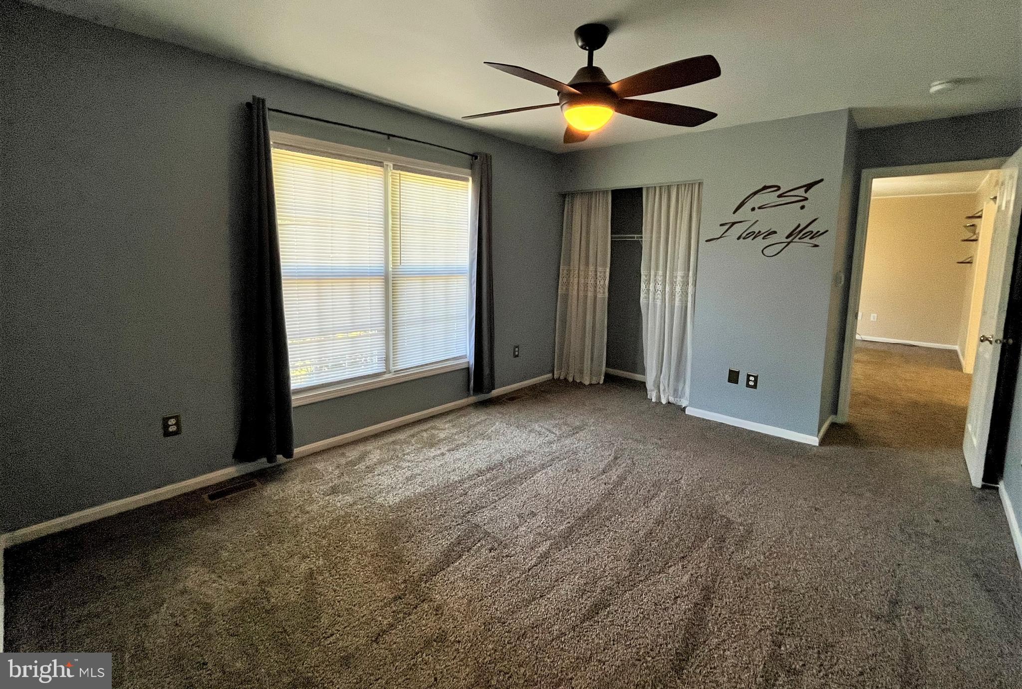 157 Cove Point Road Lusby, MD 20657 - Photo 14 of 19 an empty room with windows and fan