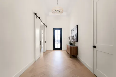 a view of a hallway view with wooden floor and staircase