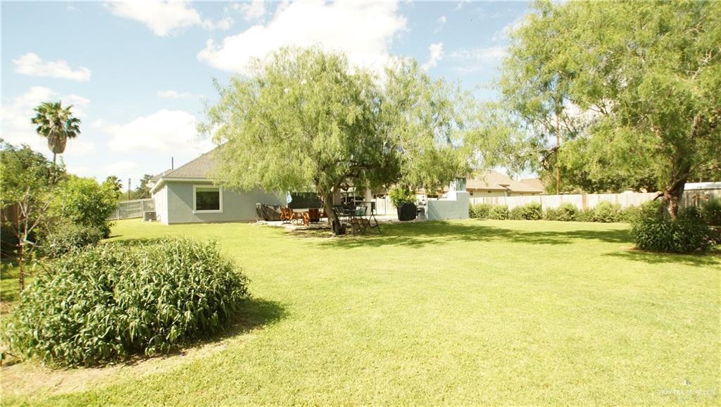 414 Ric Mar Street Edinburg, TX 78541 - Photo 8 of 36 Expansive backyard featuring a lush lawn and mature trees