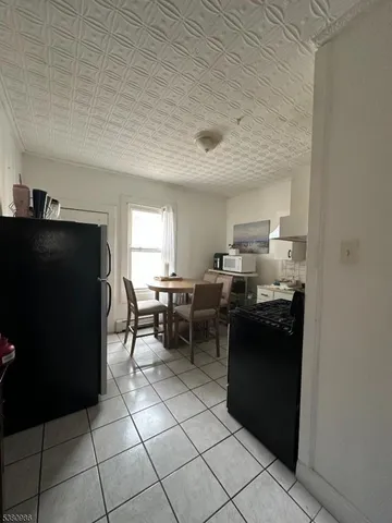 a kitchen with a sink and a refrigerator