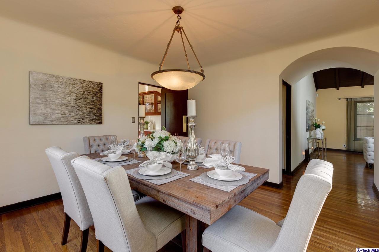 3301 Mount Curve Avenue Altadena, CA 91001 - Photo 12 of 29 a view of a dining room and livingroom with furniture wooden floor a chandelier