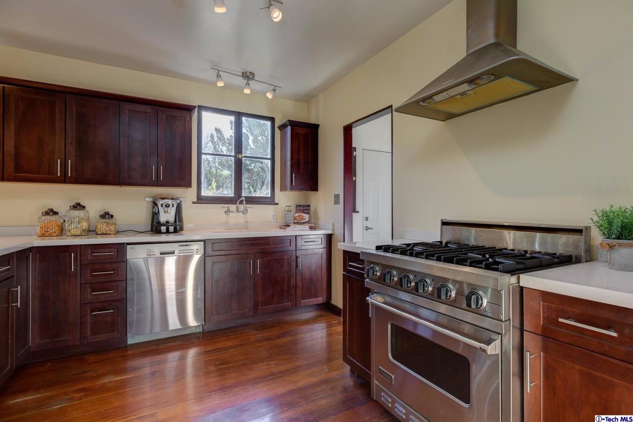 3301 Mount Curve Avenue Altadena, CA 91001 - Photo 20 of 29 a kitchen with stainless steel appliances wooden floors and wooden cabinets