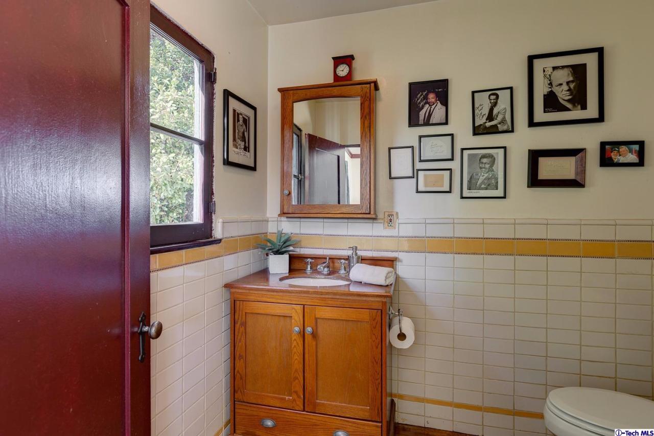 3301 Mount Curve Avenue Altadena, CA 91001 - Photo 23 of 29 a bathroom with a sink mirror vanity and toilet