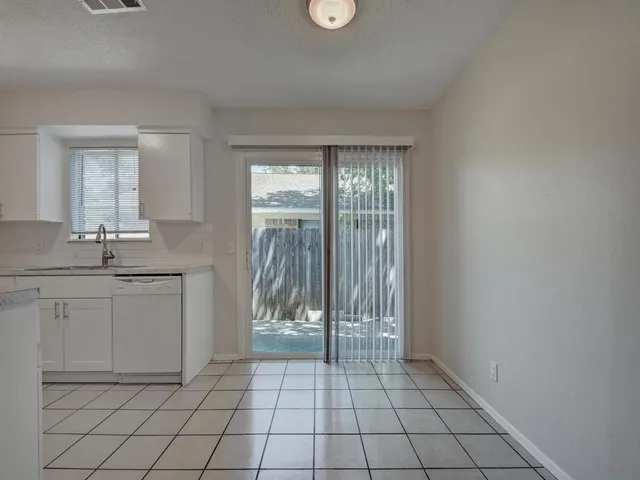 a kitchen with a stove sink and cabinets