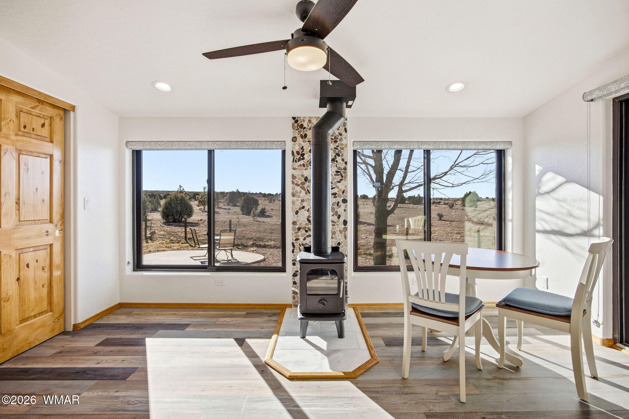 2660 Palomino Trail Overgaard, AZ 85933 - Photo 14 of 60 a view of a livingroom with furniture wooden floor and a floor to ceiling window