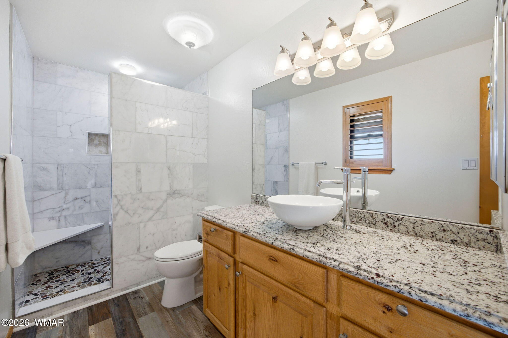 2660 Palomino Trail Overgaard, AZ 85933 - Photo 15 of 60 a bathroom with a granite countertop sink a toilet a mirror and shower
