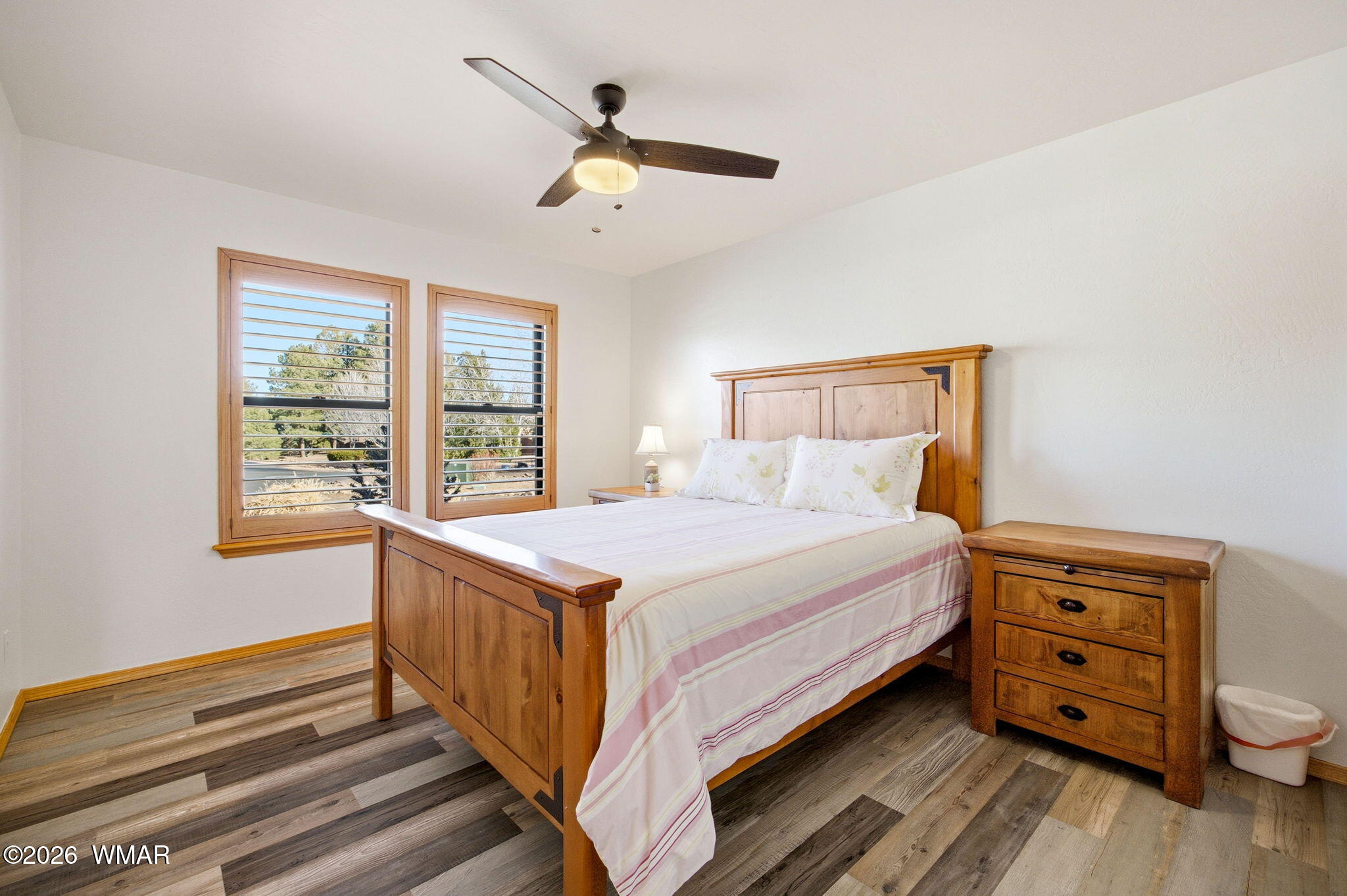 2660 Palomino Trail Overgaard, AZ 85933 - Photo 17 of 60 a bedroom with a bed and a dresser next to a window
