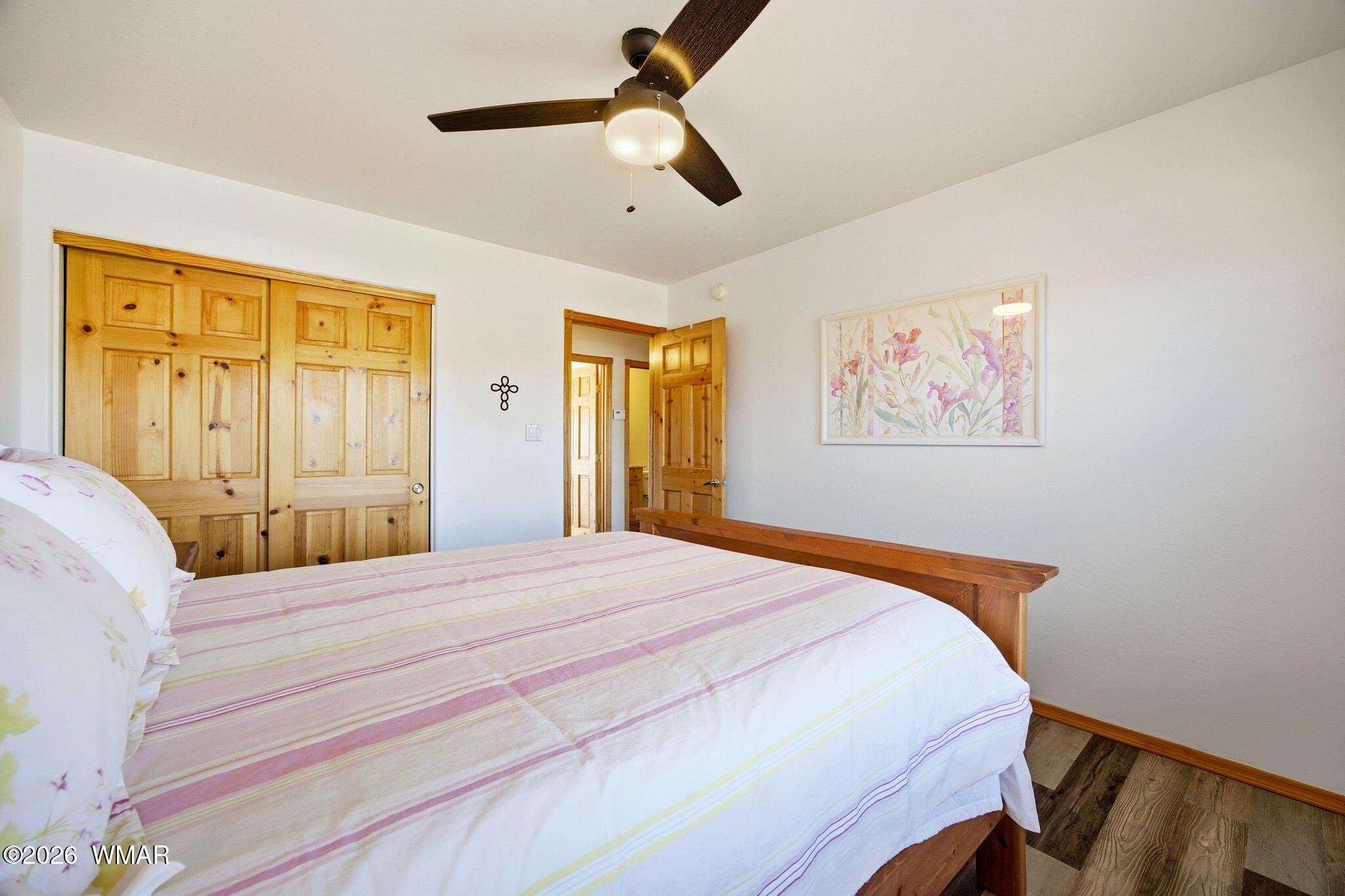 2660 Palomino Trail Overgaard, AZ 85933 - Photo 18 of 60 a bedroom with a bed and a chandelier