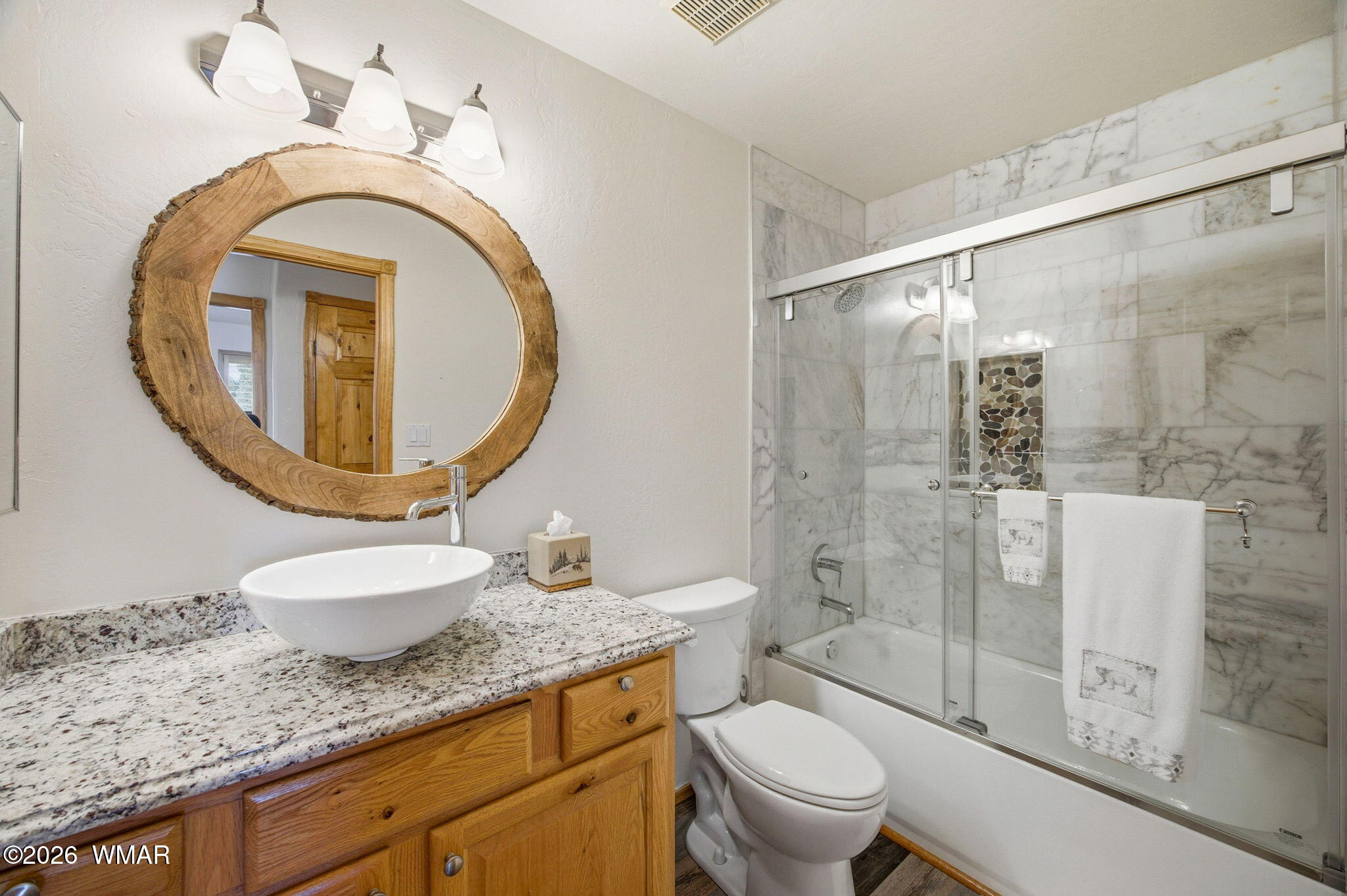 2660 Palomino Trail Overgaard, AZ 85933 - Photo 21 of 60 a bathroom with a granite countertop toilet sink and mirror
