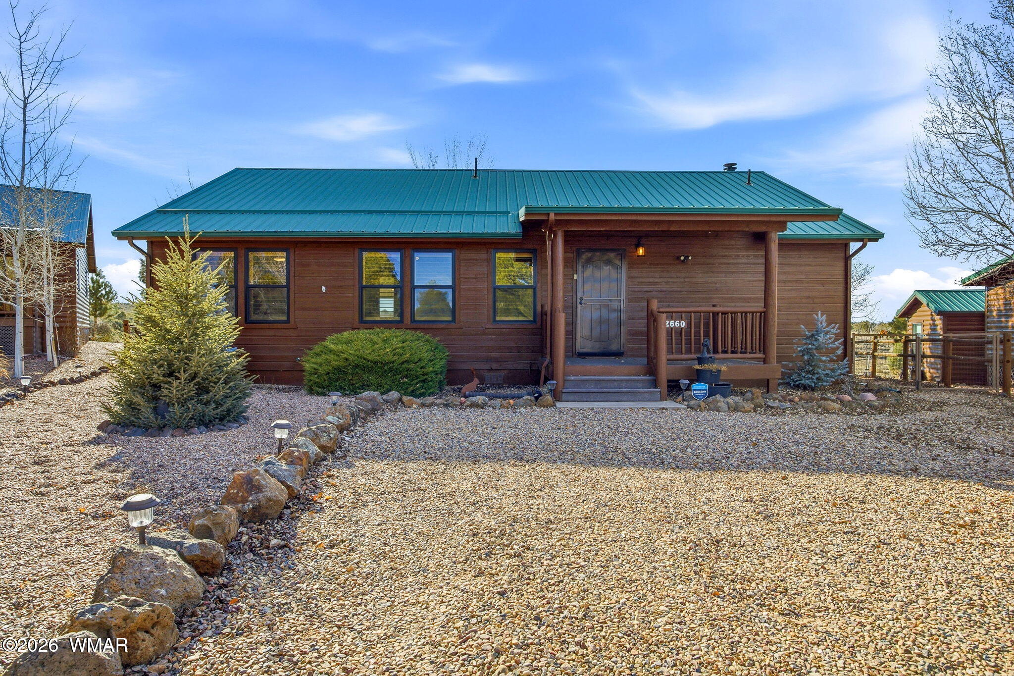 2660 Palomino Trail Overgaard, AZ 85933 - Photo 38 of 60 a front view of a house with garden