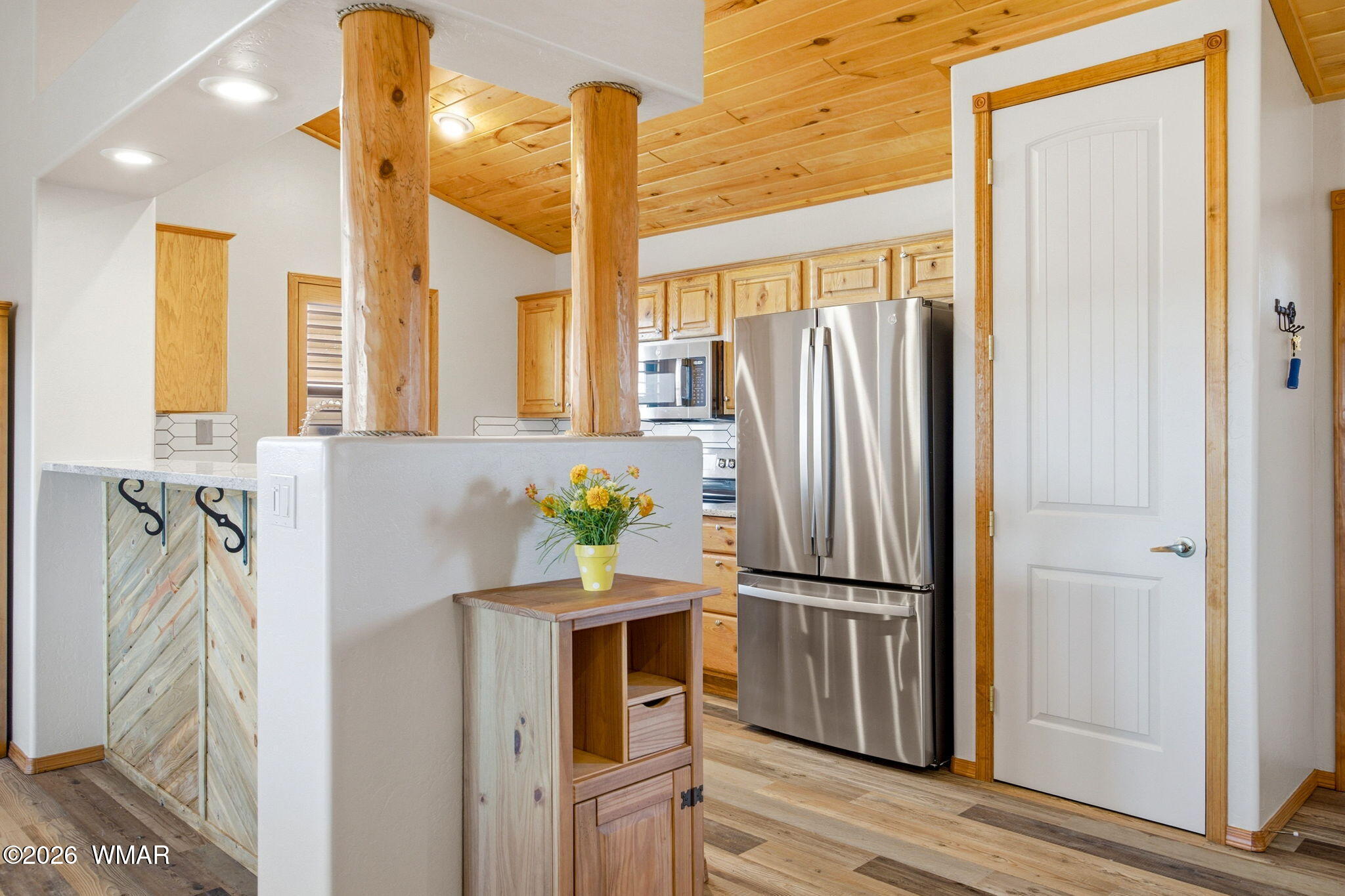 2660 Palomino Trail Overgaard, AZ 85933 - Photo 7 of 60 a kitchen with stainless steel appliances granite countertop a refrigerator and a wooden floor