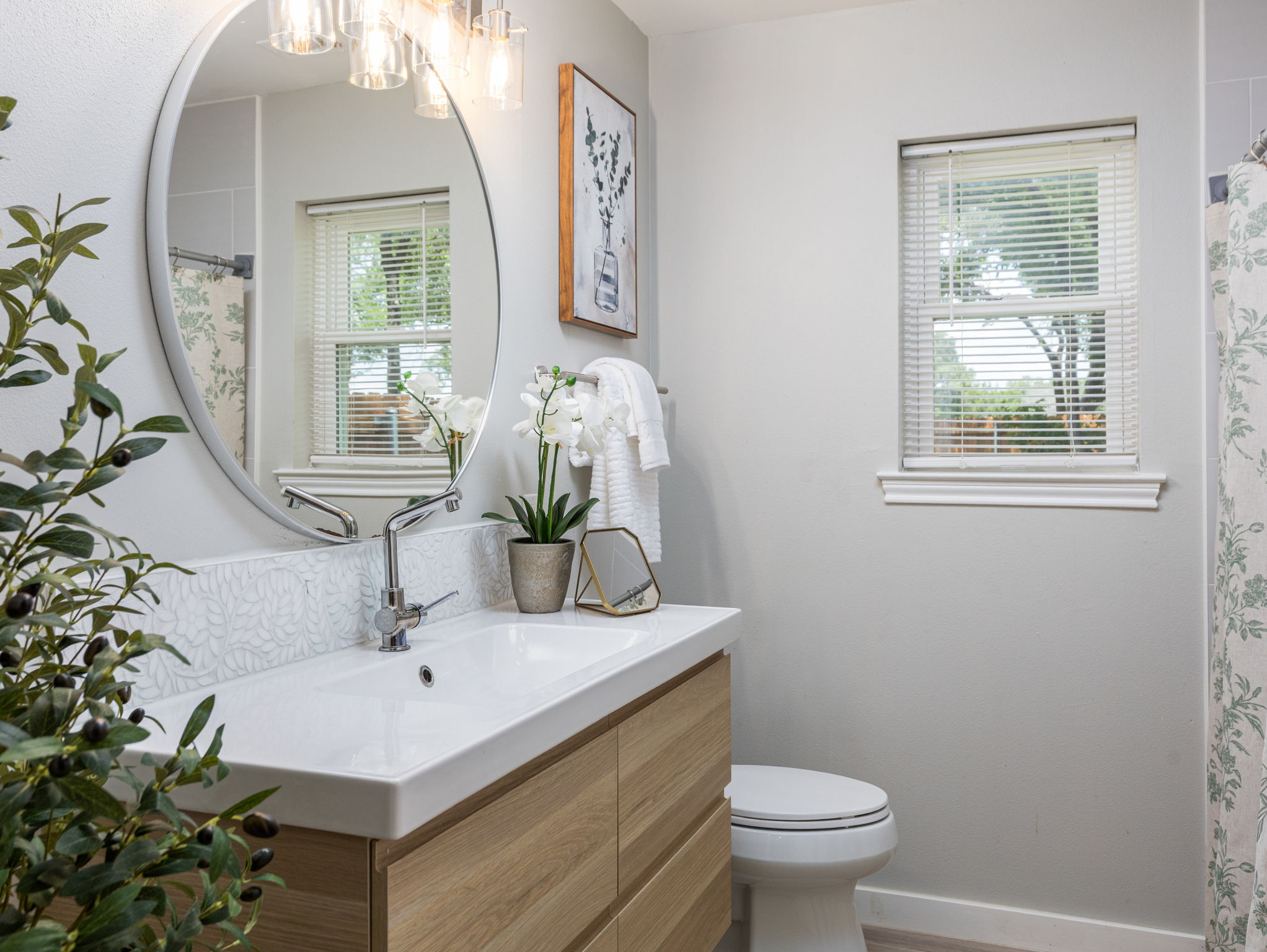 3001 County Road 255 Georgetown, TX 78633 - Photo 19 of 35 A well-lit bathroom sits between Bedrooms #2 and #3 and features a spacious vanity with a sleek, modern sink and a window providing natural illumination.
