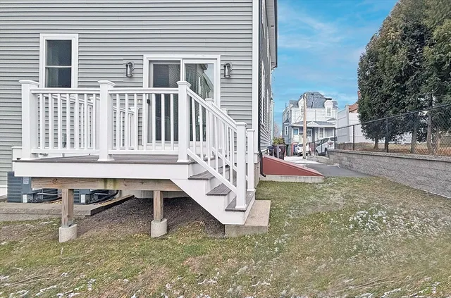 a view of roof deck with table and chairs a barbeque with wooden fence