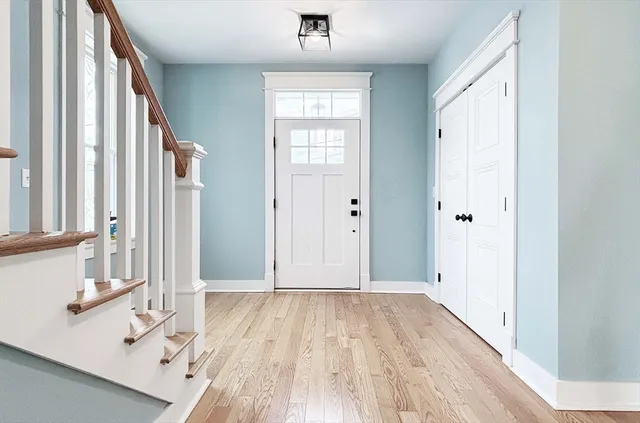 a view of a hallway with wooden floor and staircase