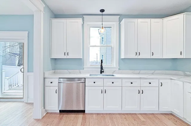 a kitchen with white cabinets