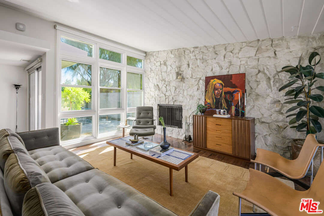 a living room with furniture a rug and a window