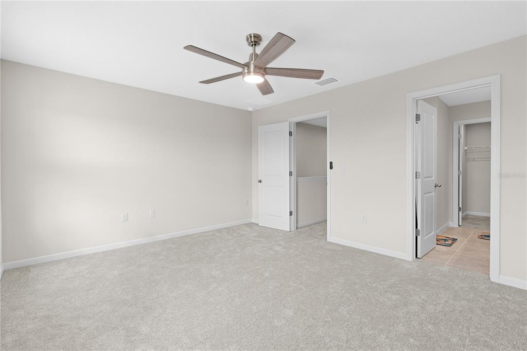 12003 Grizzly Lane New Port Richey, FL 34654 - Photo 28 of 43 an empty room with ceiling fan and window