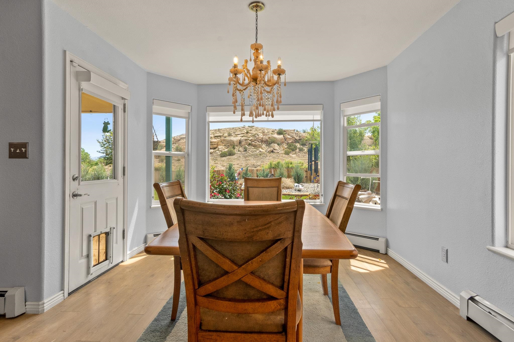 398 Butte Court Grand Junction, CO 81507 - Photo 7 of 33 a dining room with furniture a chandelier and wooden floor