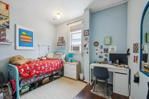 a bedroom with a bed and a desk