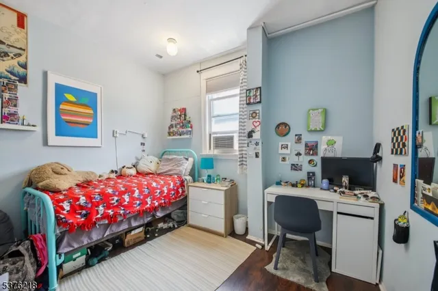 a bedroom with a bed and a desk