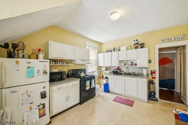 a kitchen with cabinets and appliances