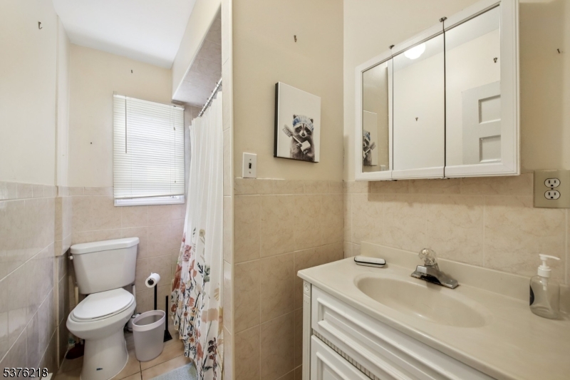44 Oberlin Street Maplewood, NJ 07040 - Photo 20 of 31 a bathroom with a sink a toilet and a mirror