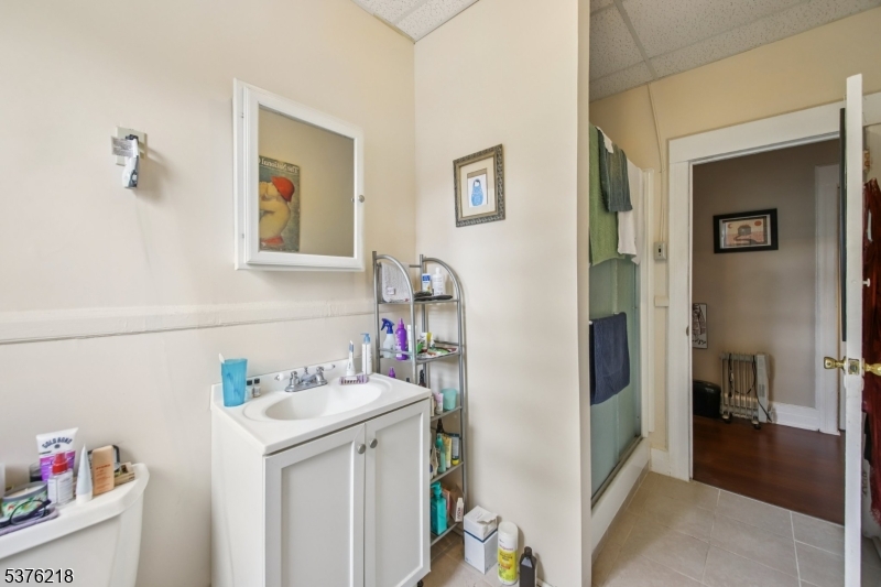 44 Oberlin Street Maplewood, NJ 07040 - Photo 21 of 31 a bathroom with a sink and a mirror