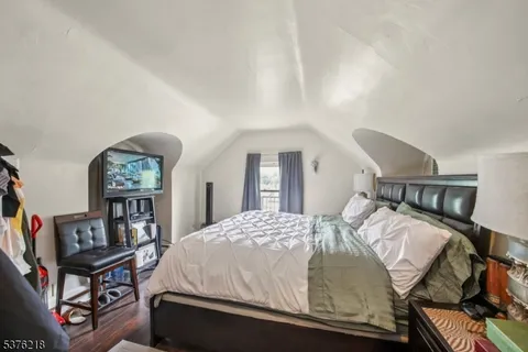 a bedroom with a bed window and dresser
