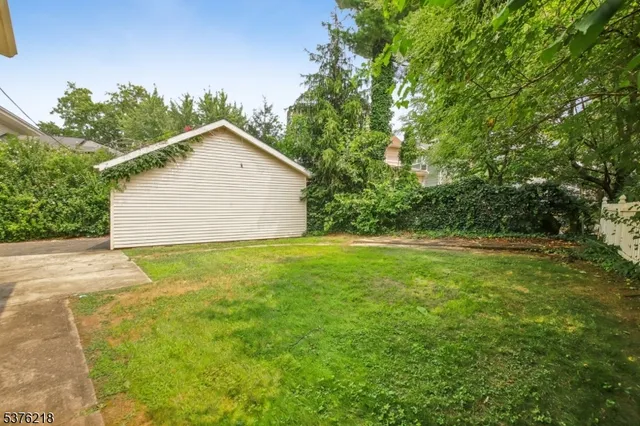 a view of backyard of house with green space