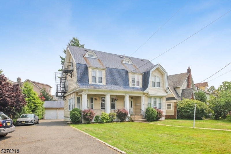 44 Oberlin Street Maplewood, NJ 07040 - Photo 30 of 31 a view of a white house with a big yard and potted plants