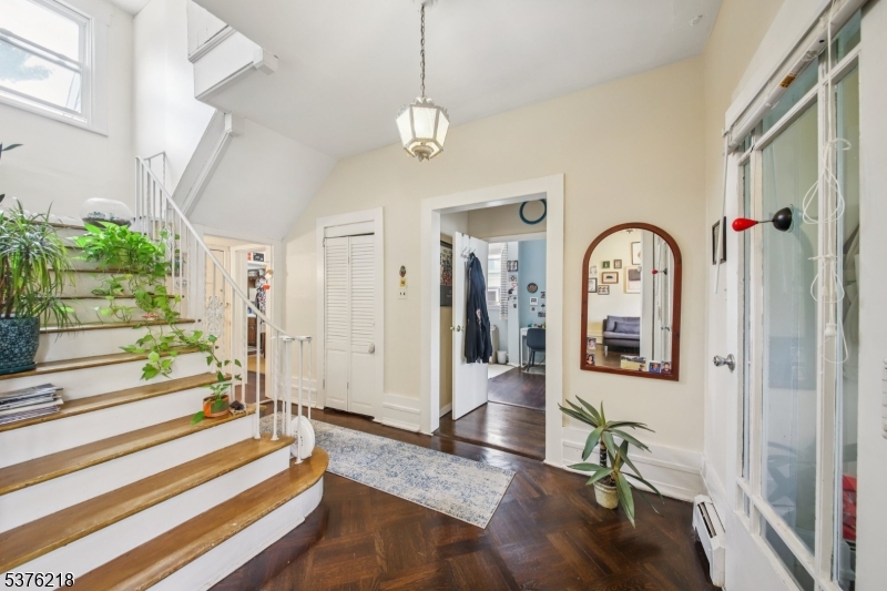 44 Oberlin Street Maplewood, NJ 07040 - Photo 3 of 31 a view of an entryway with wooden floor and mirror